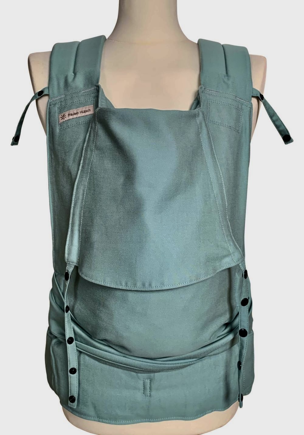 Baby Carrier Fräulein Hübsch SoftTai Toddlersize carrier in Jade Green. Shoulder straps are for tying, waist belt with buckle.